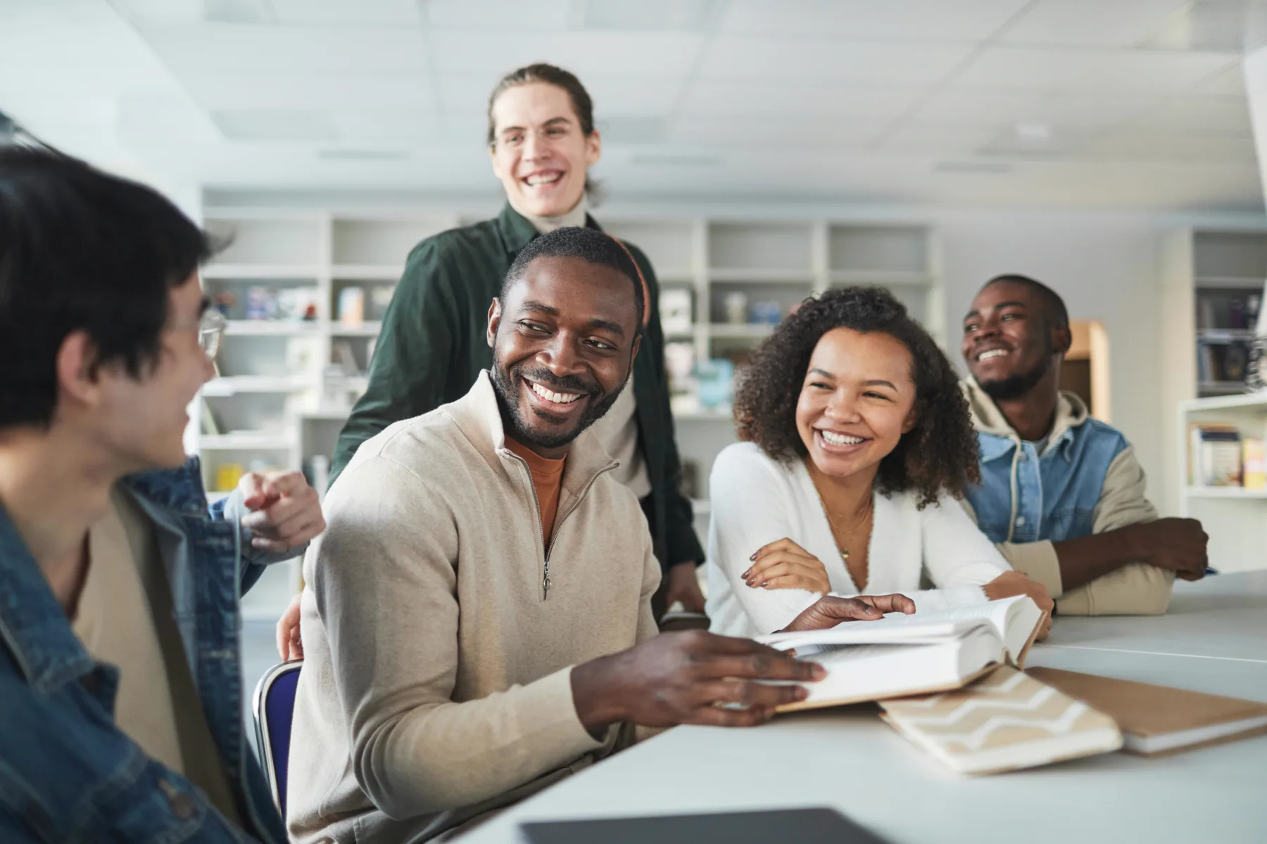 Colleagues smiling together during a workplace learning session